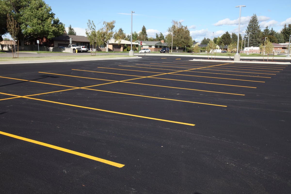 Freshly painted yellow parking lot lines showing clean, visible striping on asphalt surface